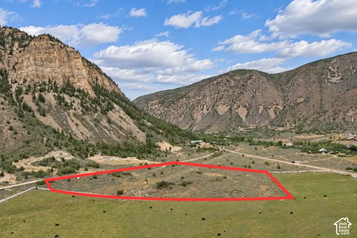 Expansive land parcel with surrounding mountainous terrain