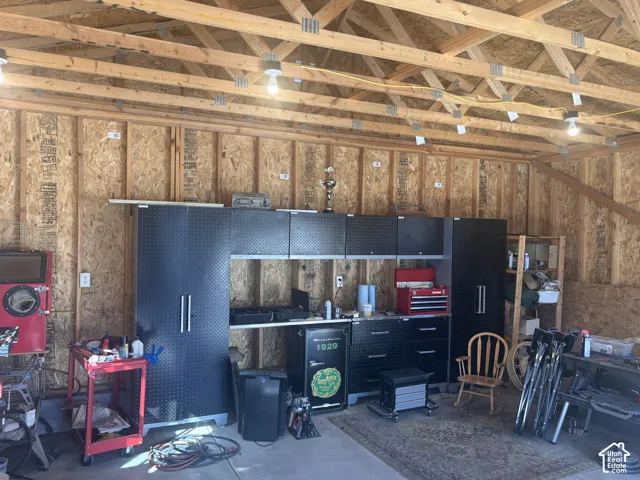 Exposed wood ceiling trusses and subfloor walls