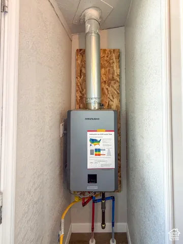 Mizudo tankless water heater with visible gas line and water connections