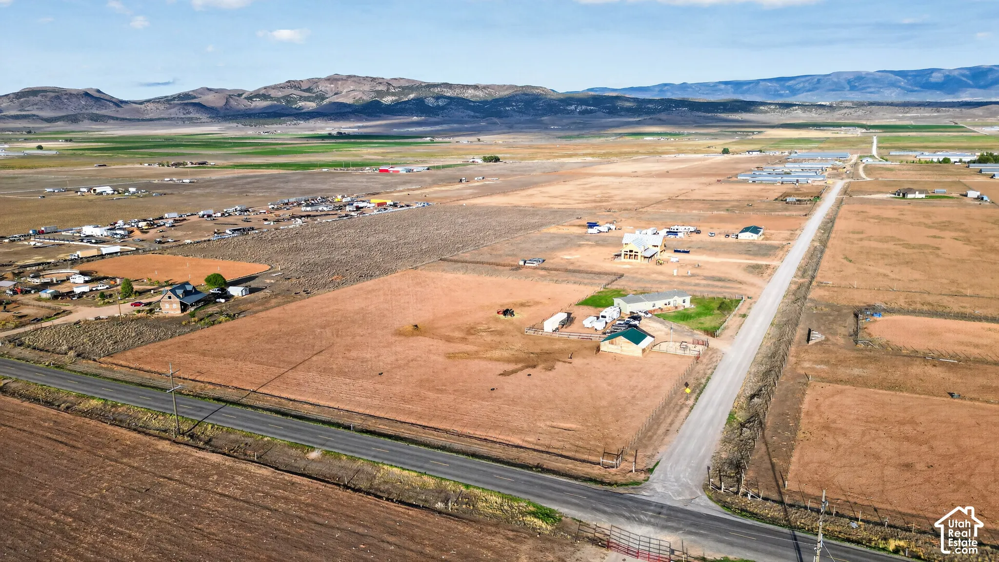 Expansive land parcel with surrounding agricultural fields and distant mountain ranges