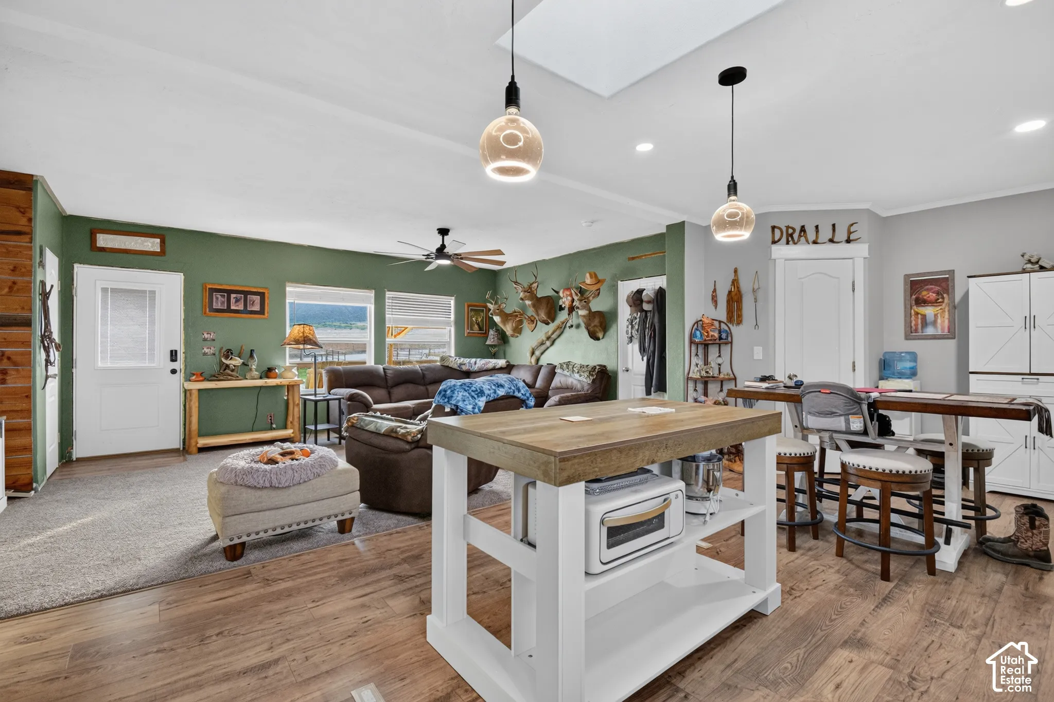 Wood-finish flooring throughout, complemented by a skylight and recessed lighting