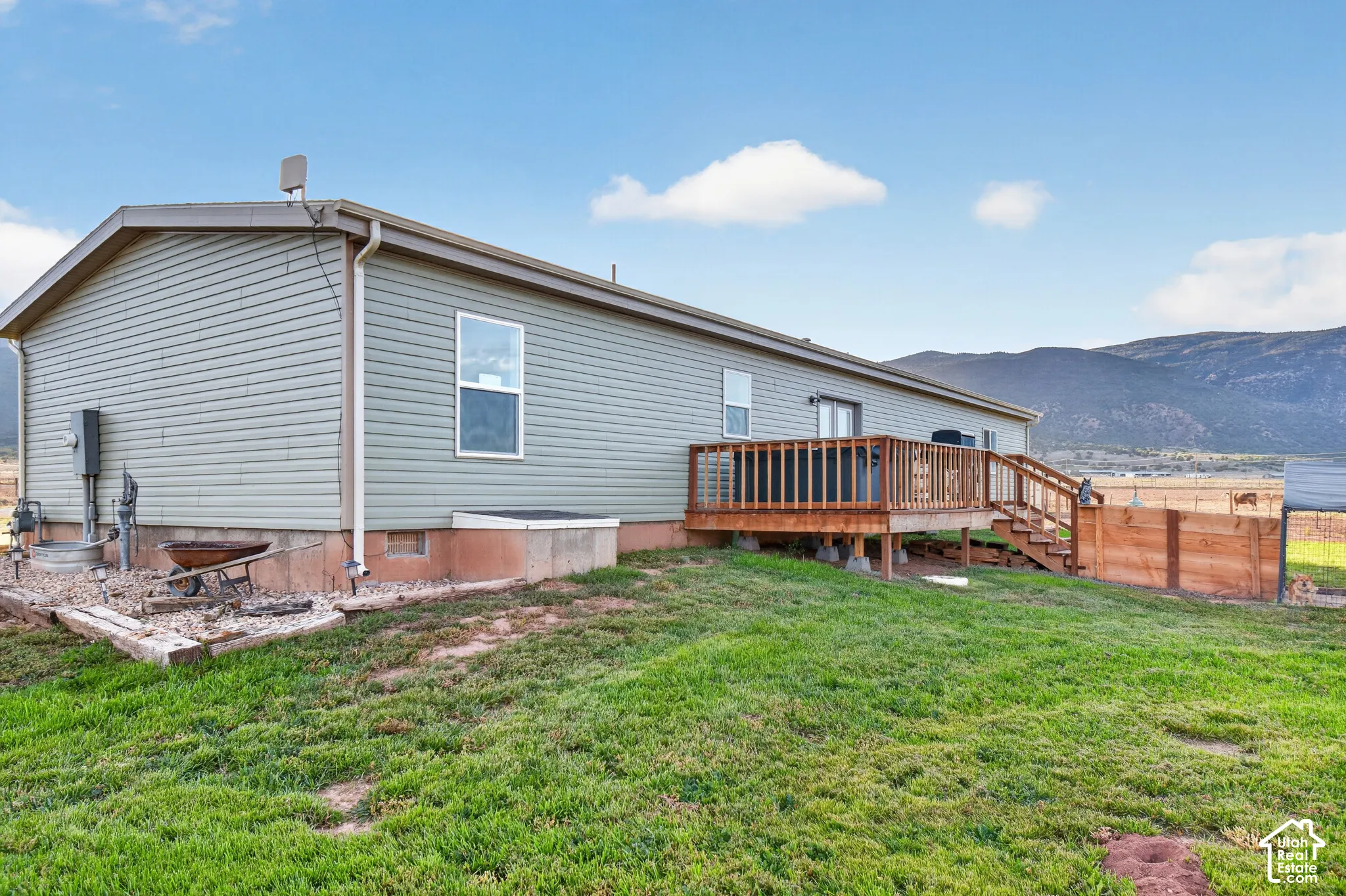 Expansive wood deck with stairs, providing outdoor living space
