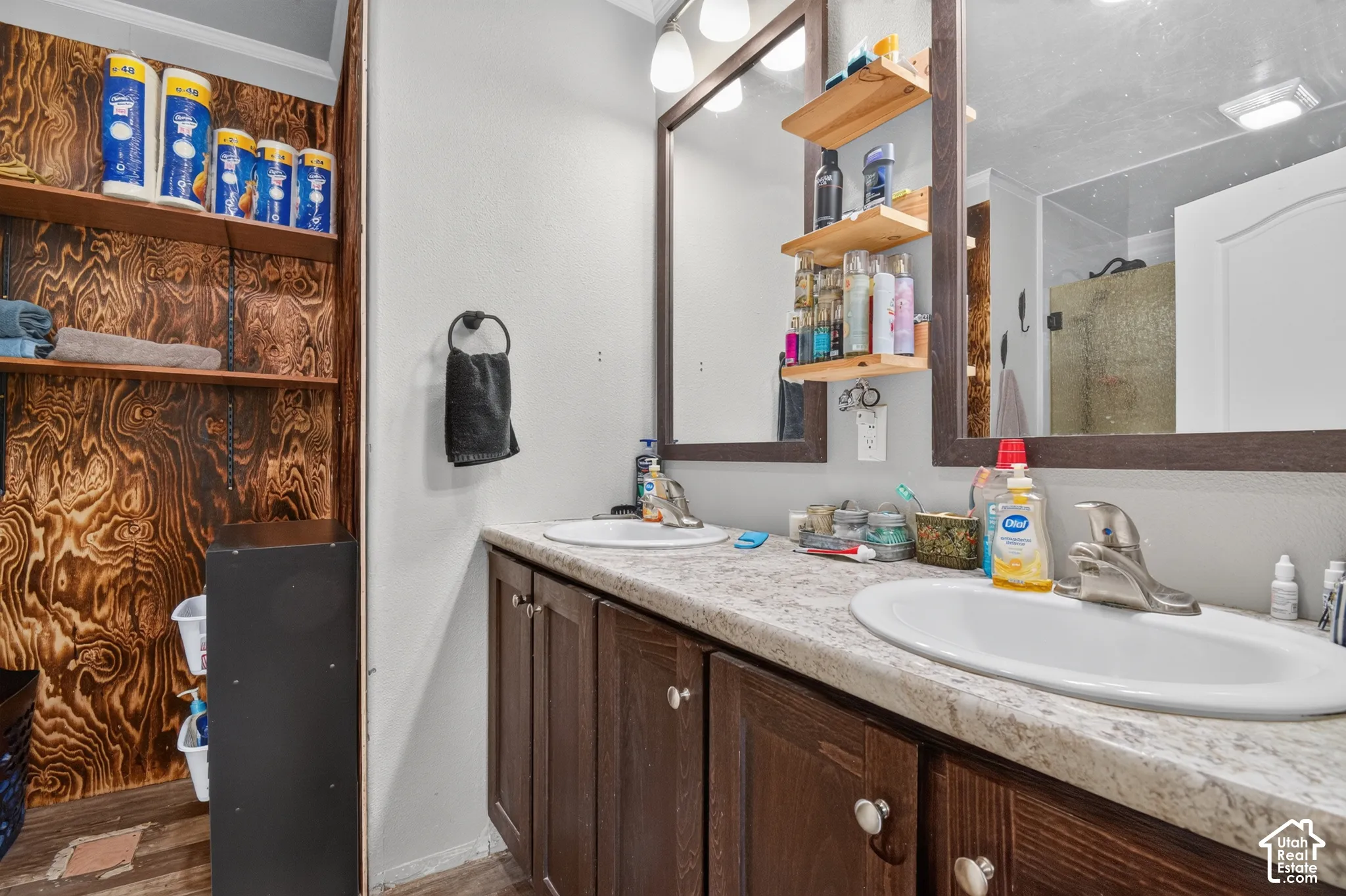 Dual vanity with laminate countertops and wood-finish cabinetry