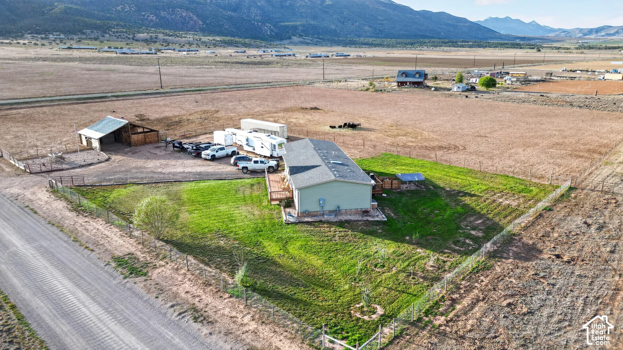 Expansive property featuring a single-story dwelling, dedicated parking area, and an accessory building