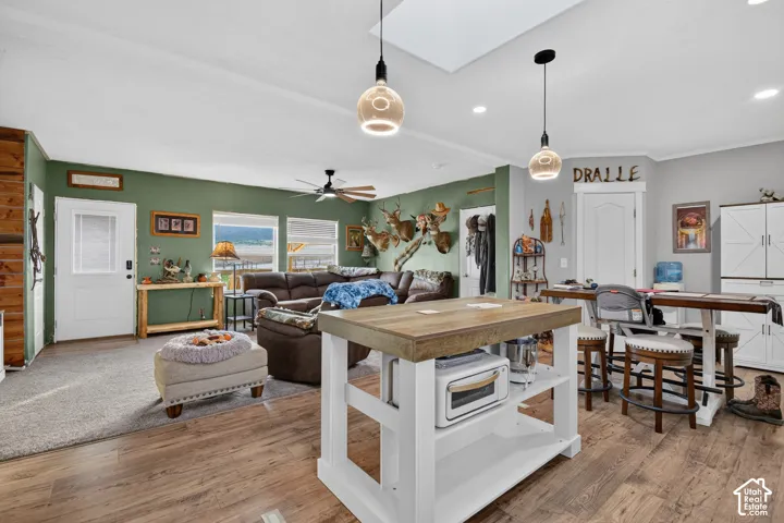Wood-finish flooring throughout, complemented by a skylight and recessed lighting