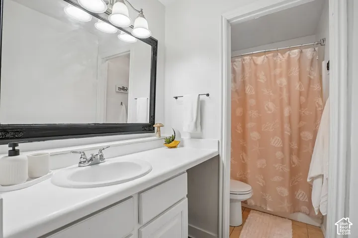White vanity with integrated sink, chrome faucet, and full-width framed mirror