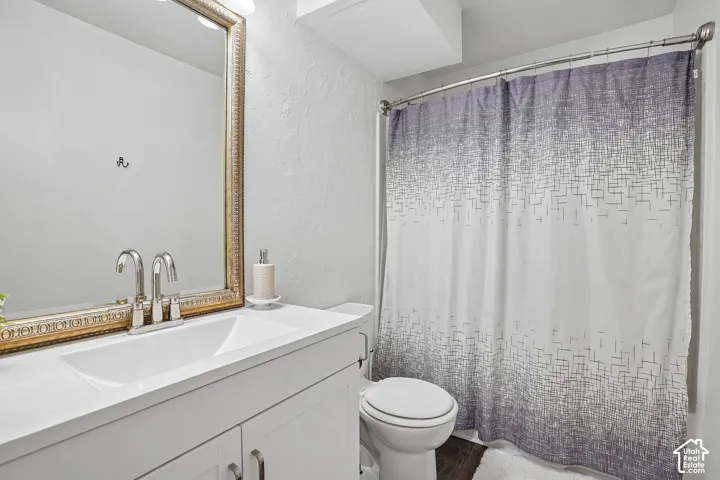 Vanity with integrated sink, brushed nickel faucet, and framed mirror