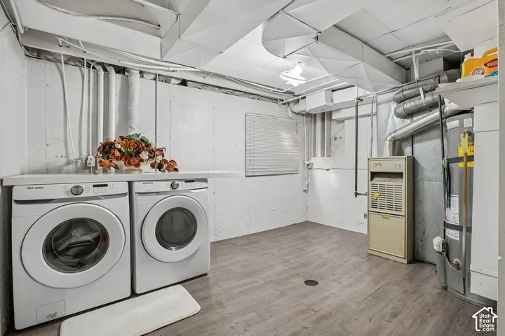 Laundry area with a built-in counter surface and wood-finish flooring