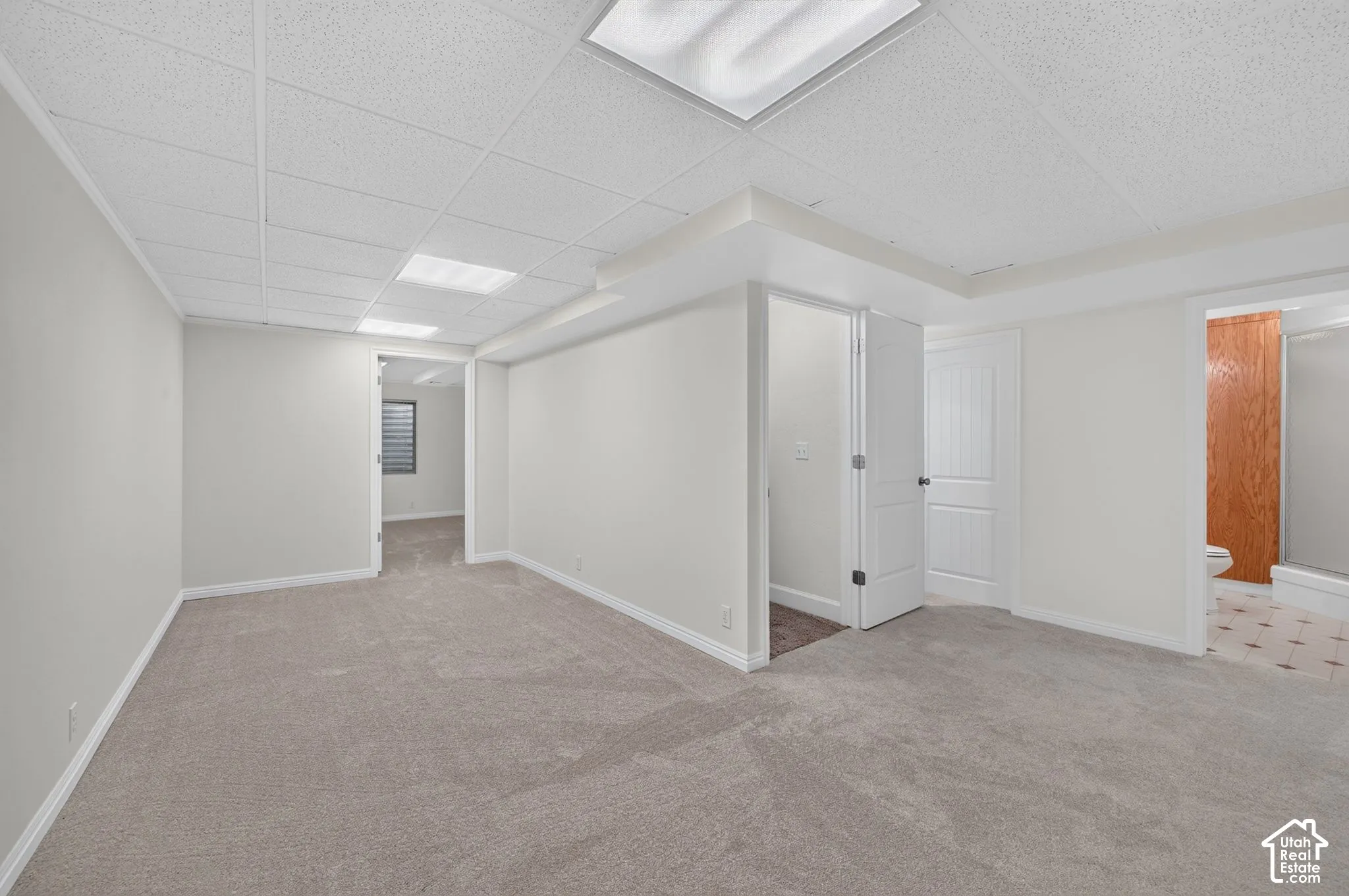 Carpeted flooring, recessed lighting, and white interior doors