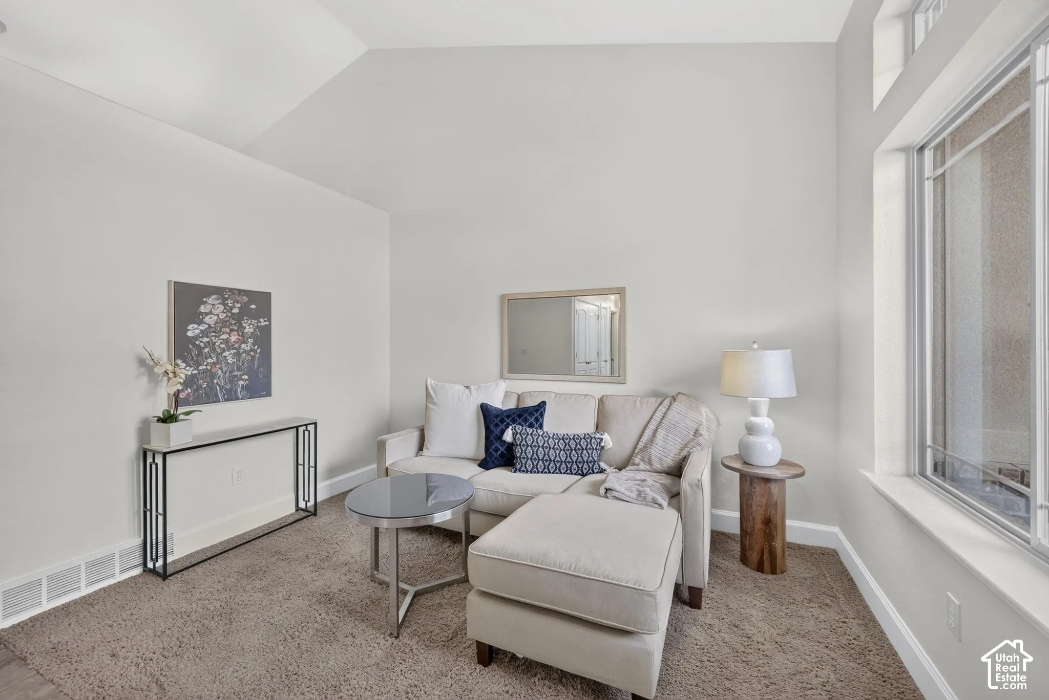 Vaulted ceilings, transom windows, neutral wall tones, and recessed lighting