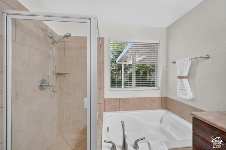 Tiled walk-in shower with clear glass enclosure and dual shower heads