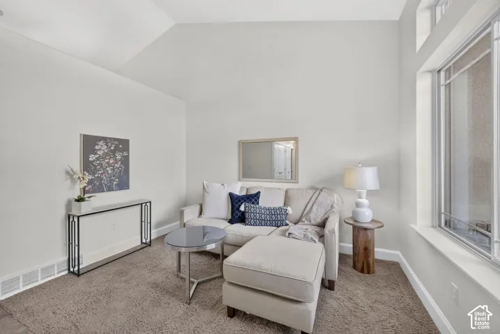 Vaulted ceilings, transom windows, neutral wall tones, and recessed lighting