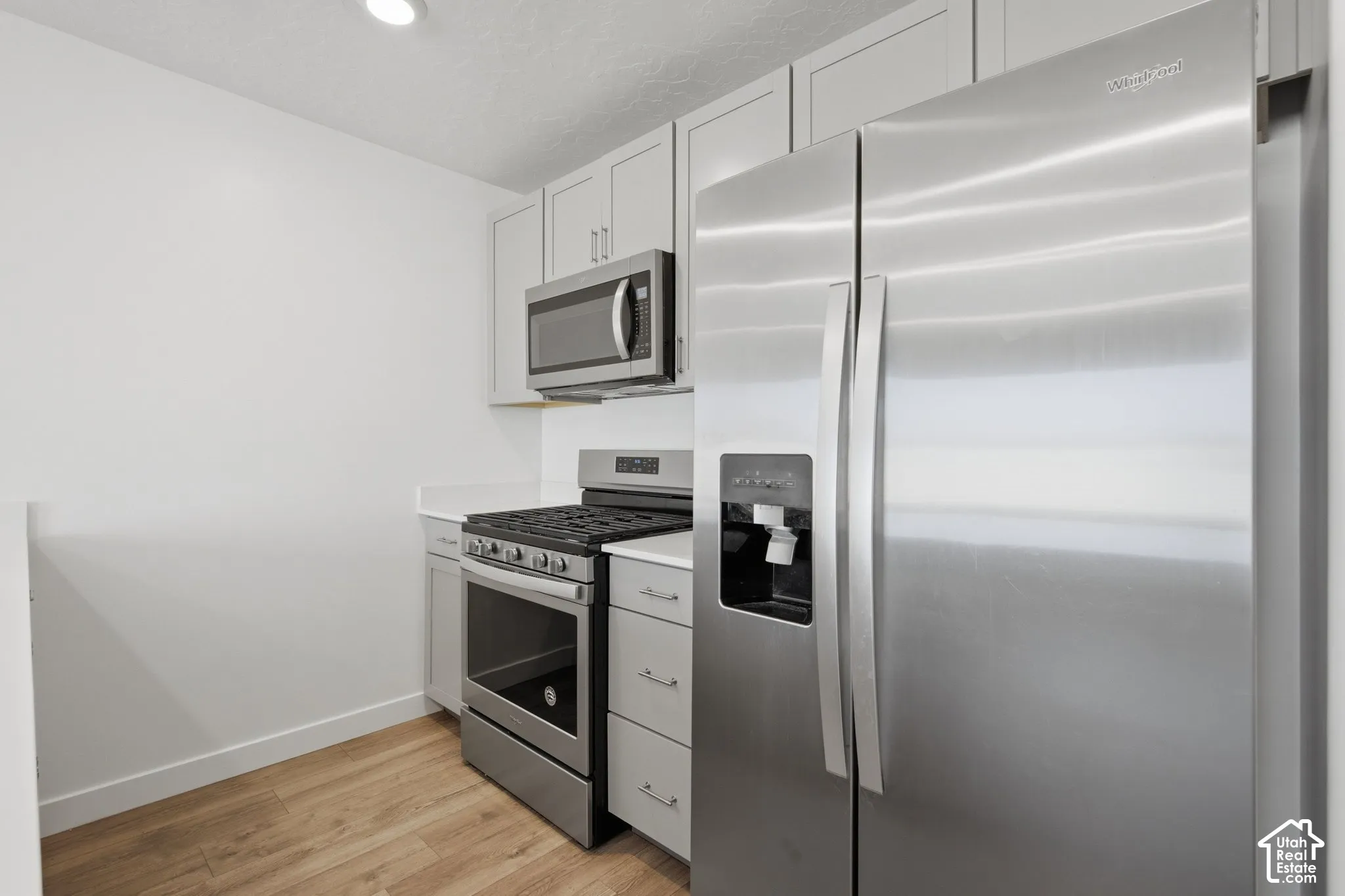 Stainless steel refrigerator, microwave, and range