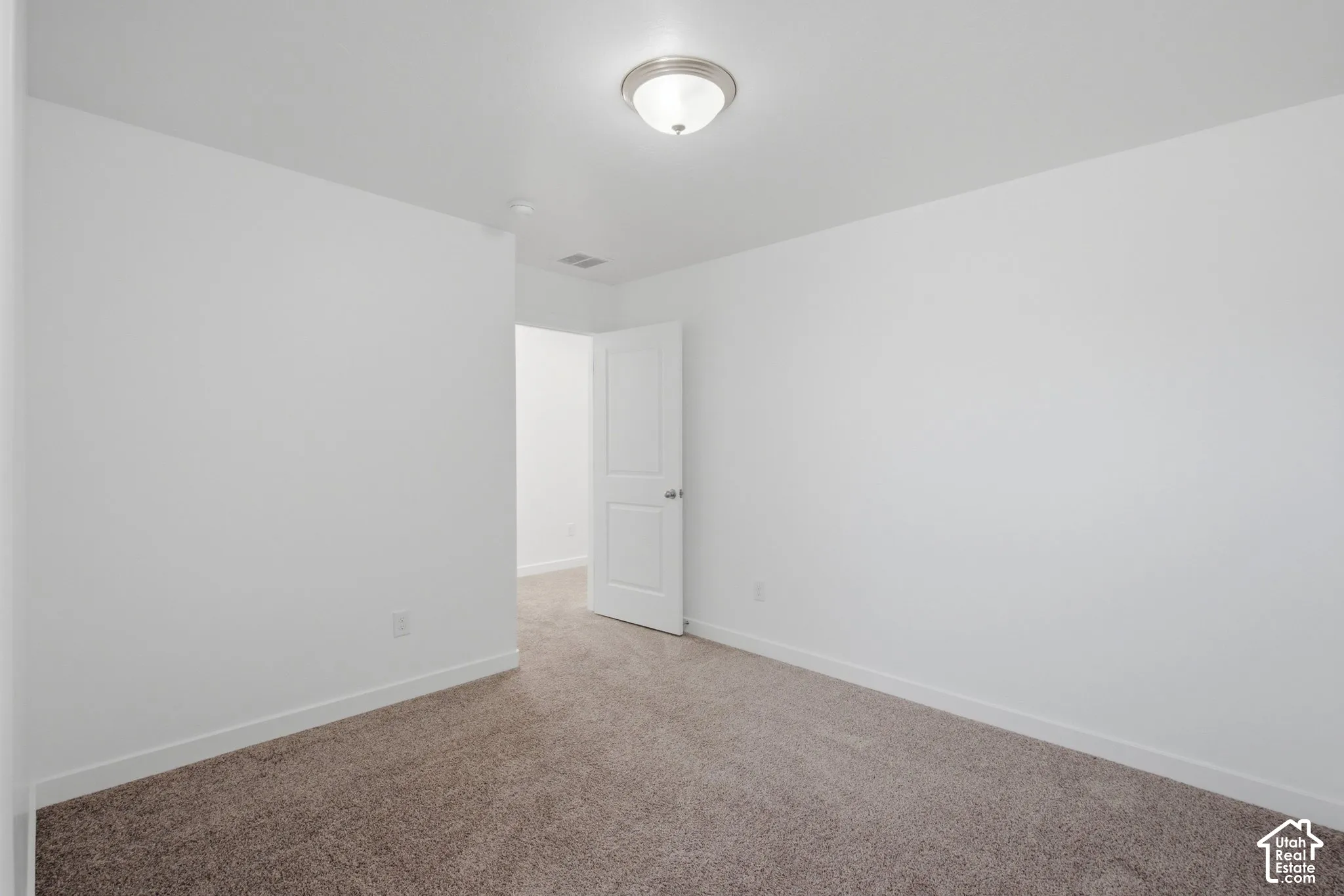 Neutral wall color complemented by carpeted flooring