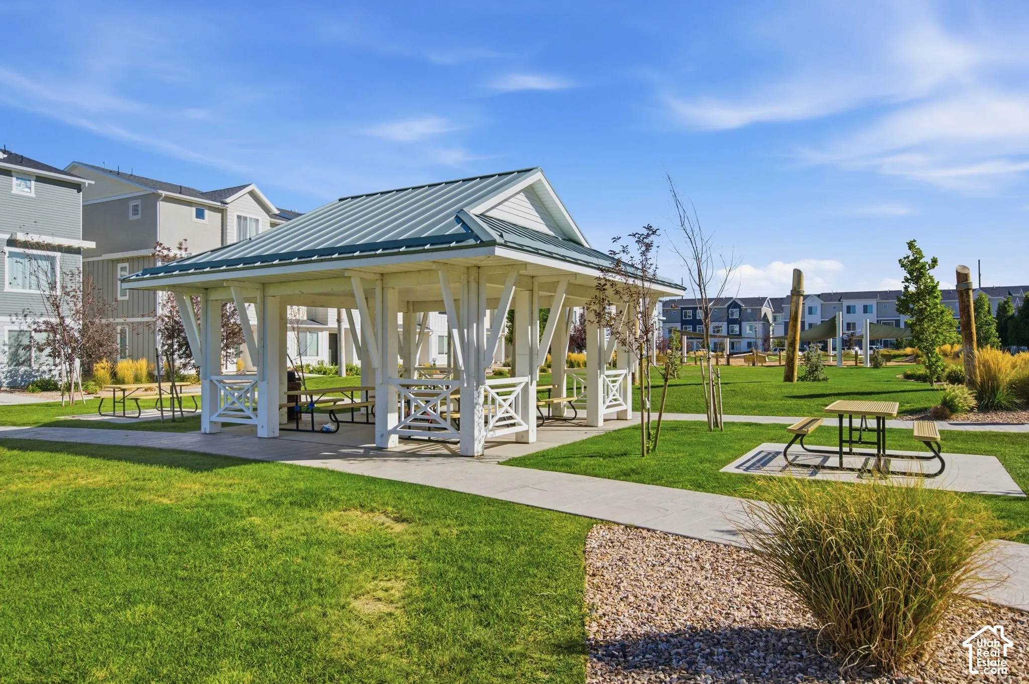 Central gazebo with a pitched roof, surrounded by a manicured lawn and mature landscaping
