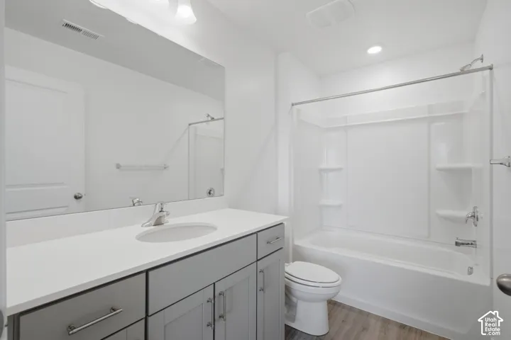 White vanity with gray cabinetry and brushed nickel hardware