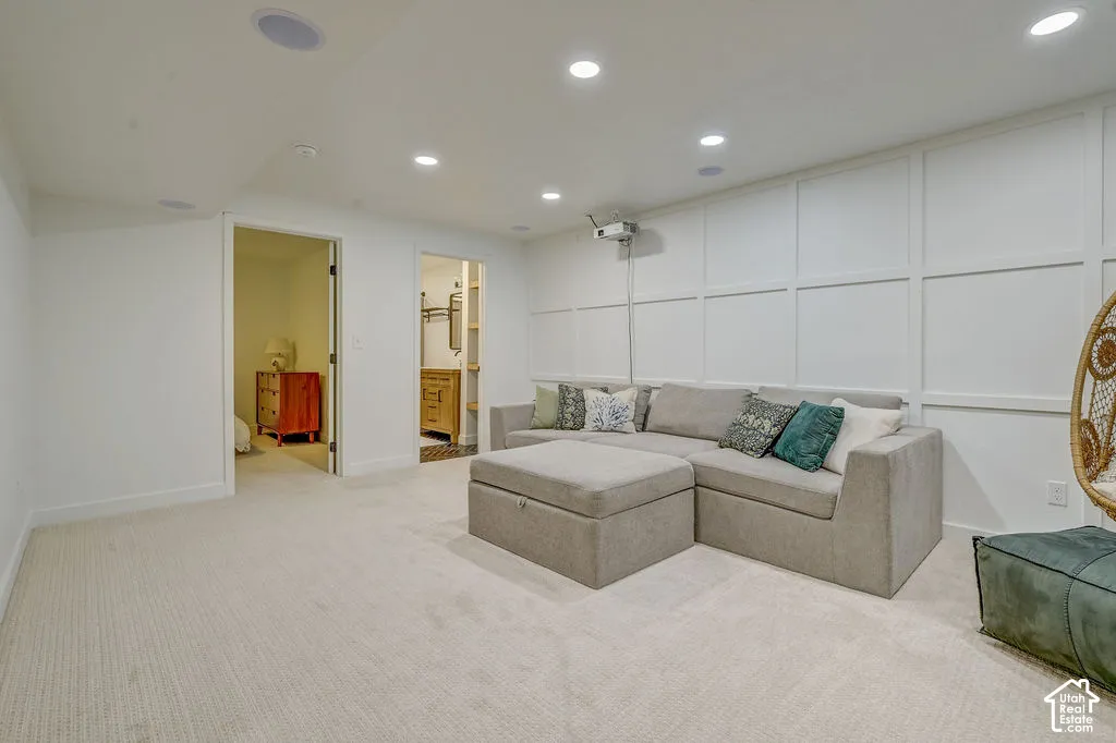 Recessed lighting, integrated ceiling speakers, and light-toned carpeting