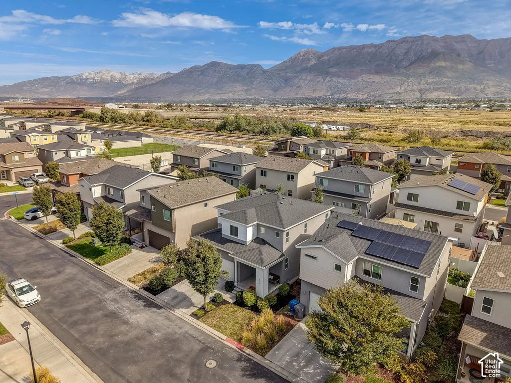 Mountain backdrop, residential street, street-facing garages, solar panels, landscaping