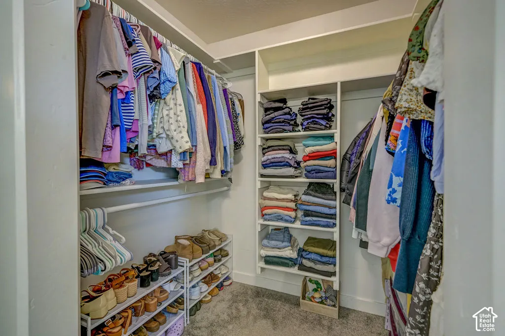Custom closet system with white shelving and hanging rods