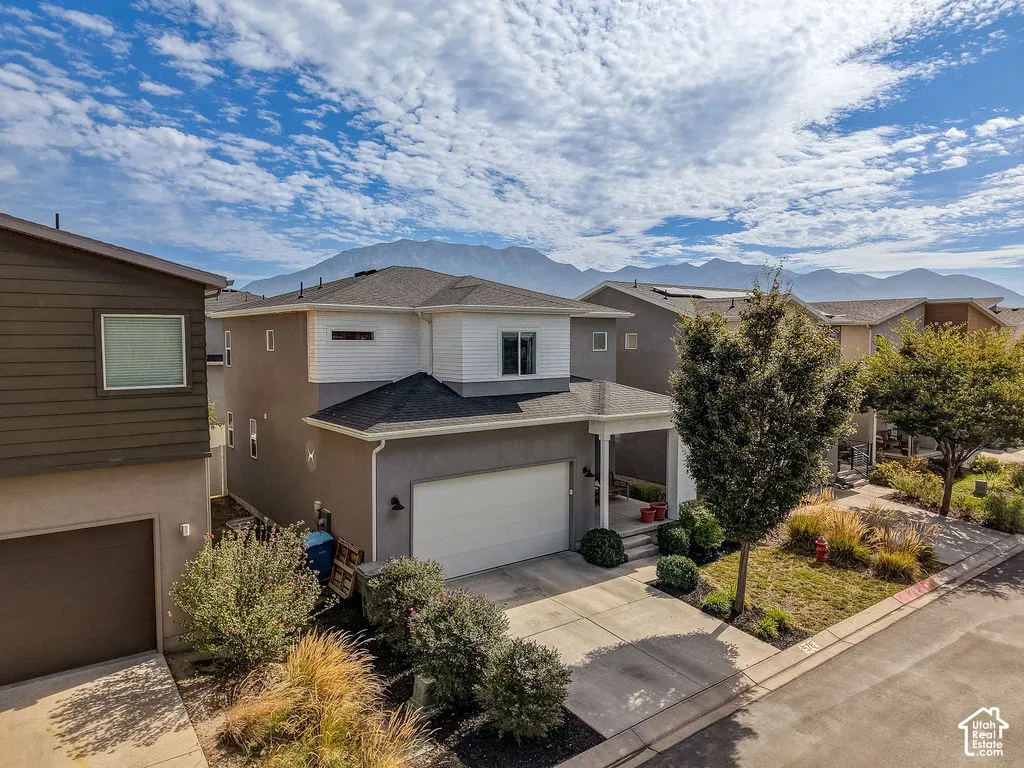 Modern two-story stucco and siding exterior with an attached garage