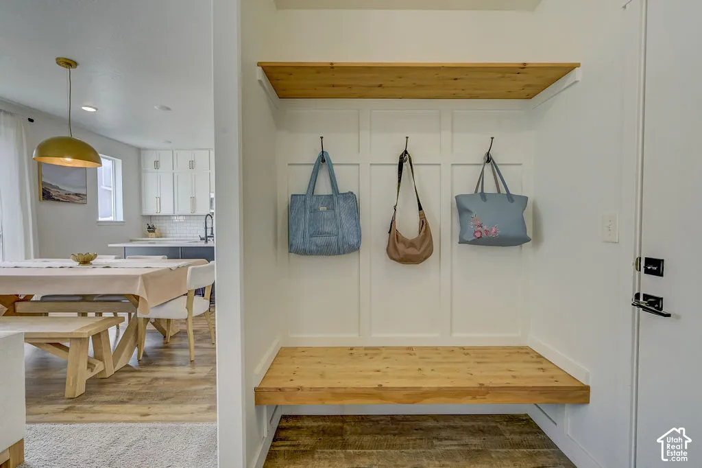 Built-in wood-finish bench with upper shelving and coat hooks