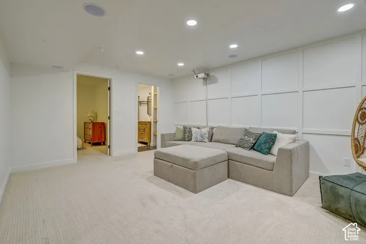 Recessed lighting, integrated ceiling speakers, and light-toned carpeting