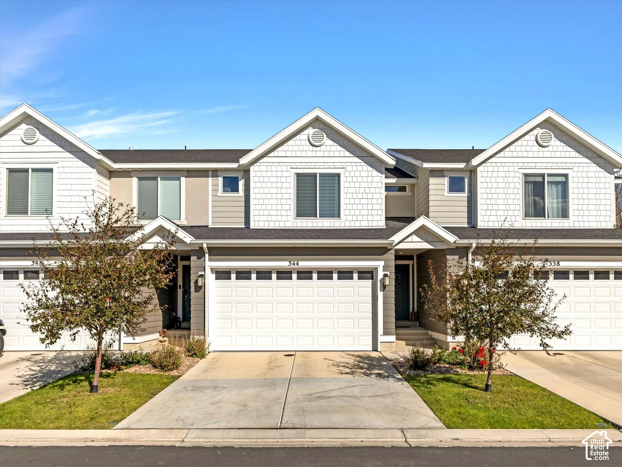 Exterior featuring a two-car garage, concrete driveway, and front entryway