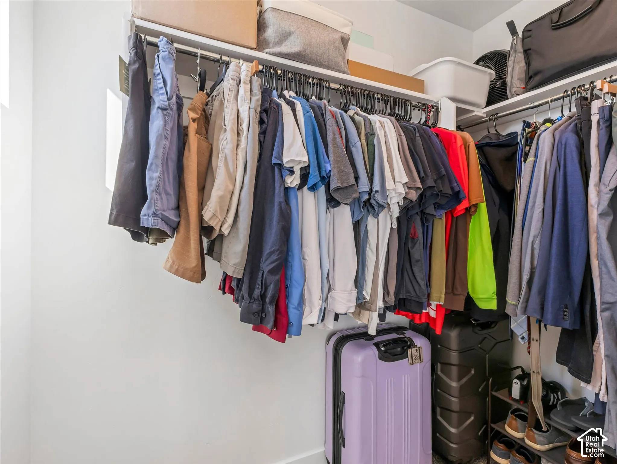 Built-in closet shelving system with multiple hanging rods