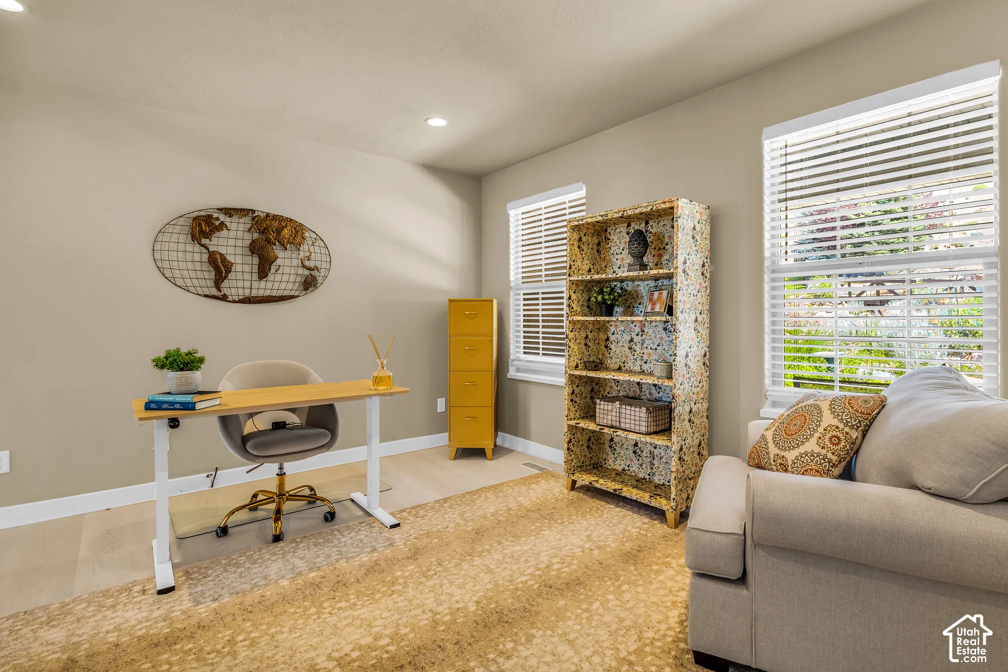 Recessed lighting, light-toned walls, wood-finish flooring, and multiple windows with blinds