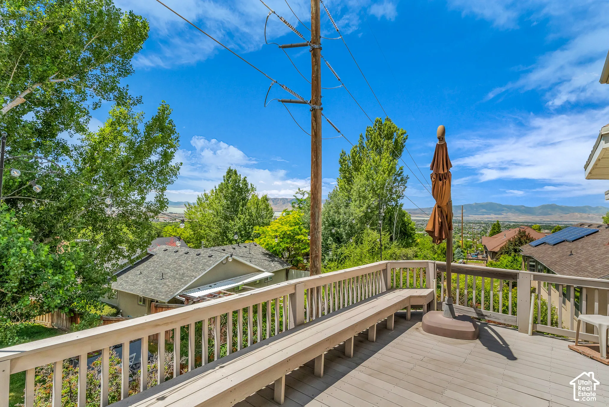 Expansive elevated deck with built-in bench seating and a wooden railing