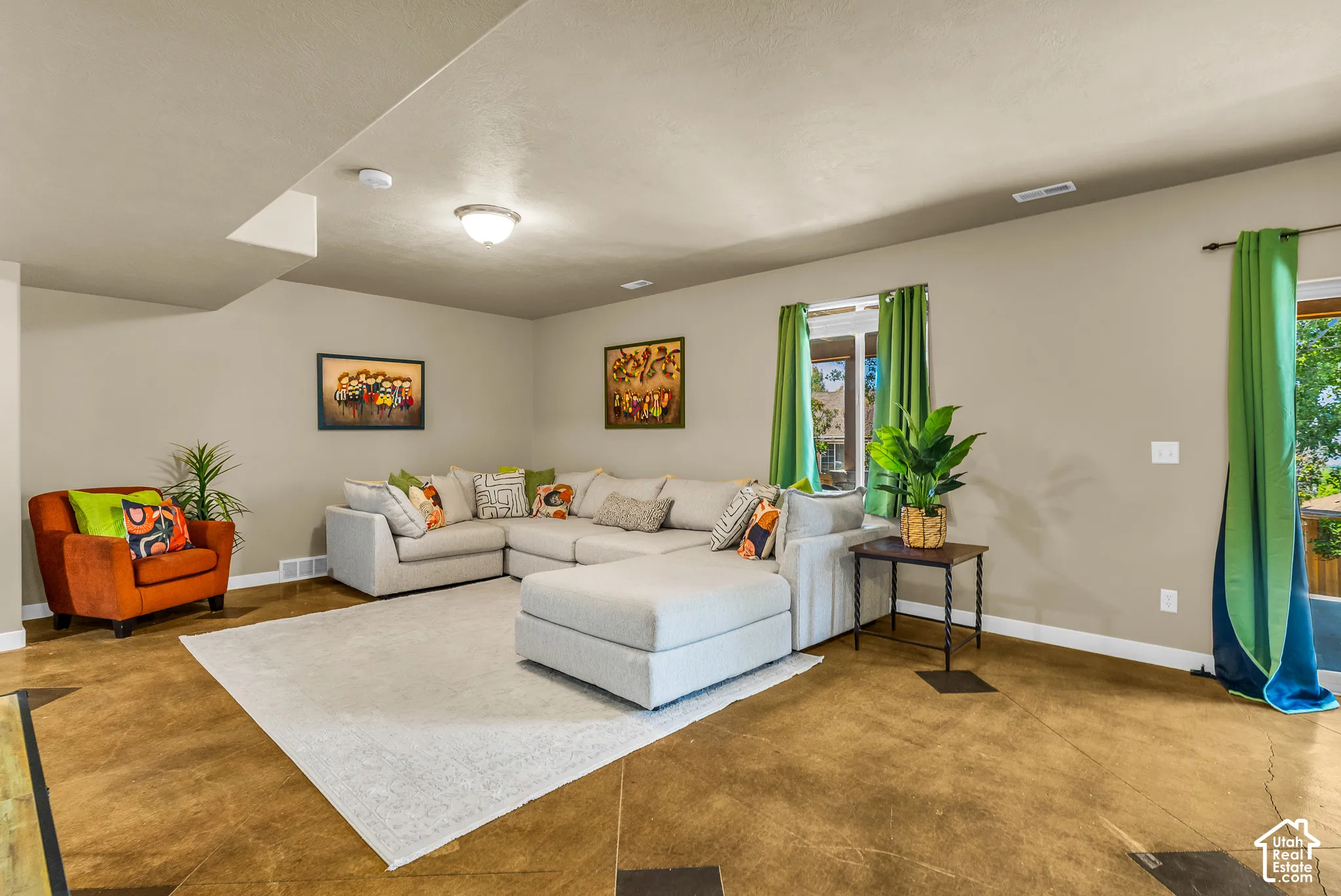 Spacious room with light-colored walls, recessed ceiling, and a flush-mount light fixture