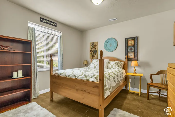 Recessed lighting, window with blinds, wood-finish flooring, built-in shelving, neutral wall color