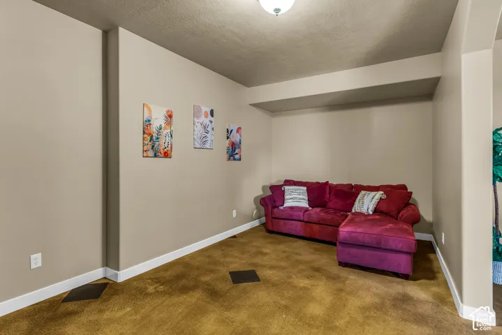 Recessed ceiling with an overhead light fixture, light neutral wall paint, and white trim