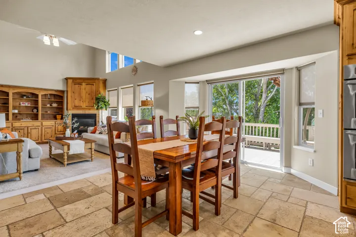 Vaulted ceilings, built-in cabinetry, tiled flooring, sliding glass door, and a built-in wall oven
