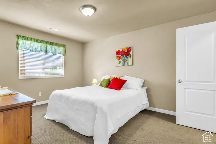 Carpeted flooring, neutral wall color, white trim, recessed ceiling light fixture, and a window with blinds