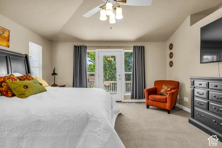 Vaulted ceiling with ceiling fan, French doors to exterior, wall-to-wall carpeting, and window with blinds