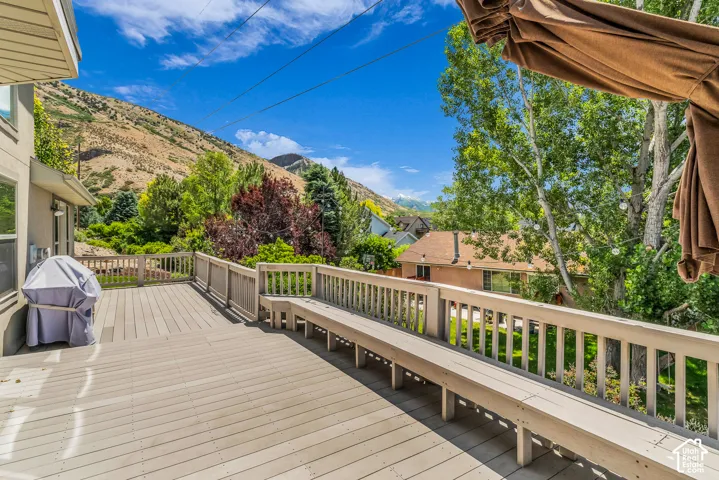 Expansive outdoor deck with built-in bench seating and wood railing