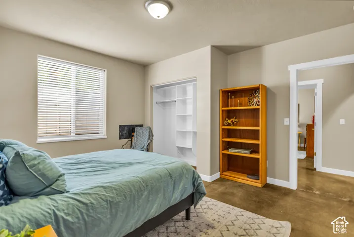 Recessed window with blinds, built-in closet shelving, and a semi-flush mount ceiling light