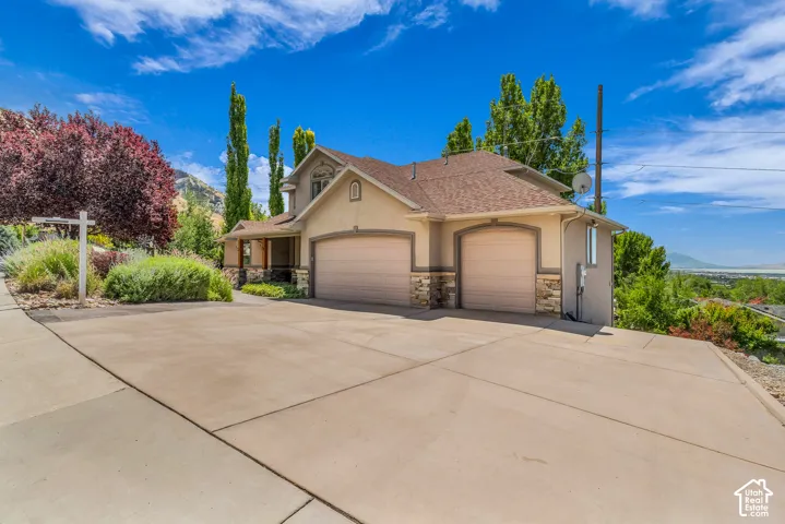 Two-story exterior with stucco finish and stone accents