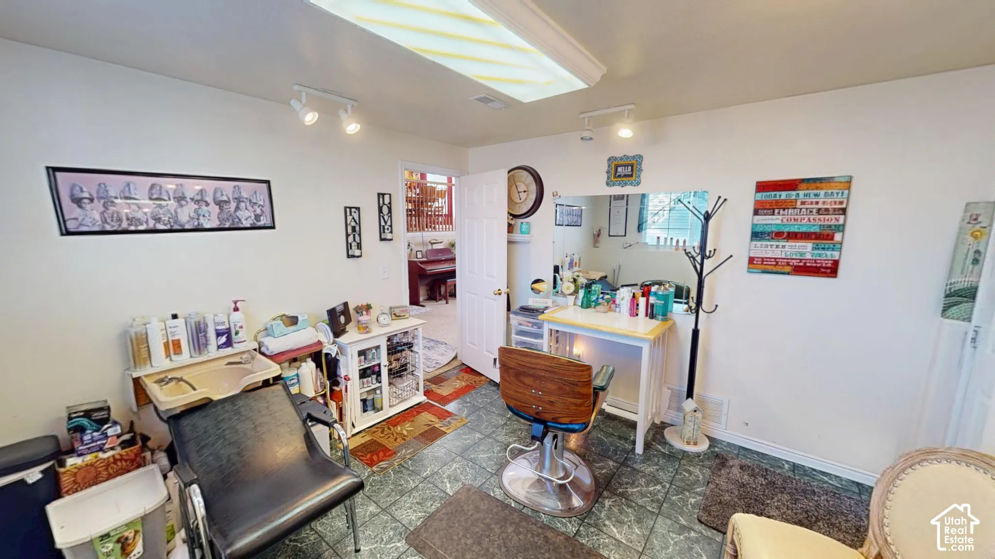 Green-hued tile flooring, white walls, recessed ceiling lighting, and track lighting fixtures