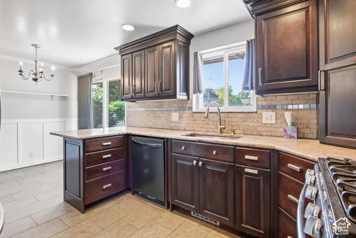 Dark wood-finish cabinetry with silver-tone hardware, light-toned countertop, and a tiled backsplash