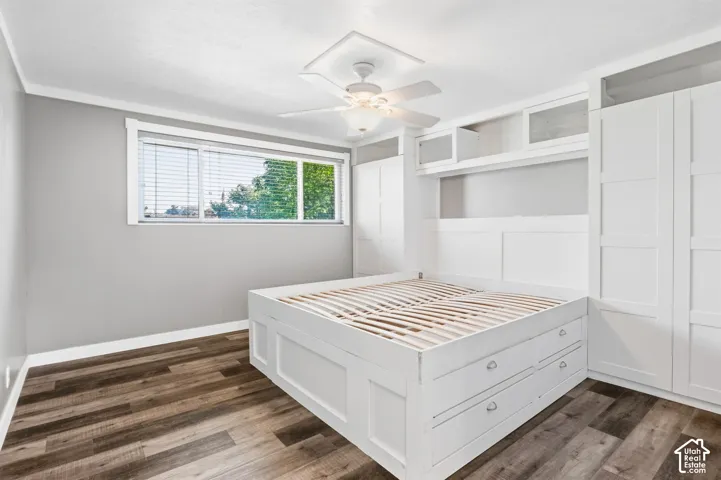 Built-in storage solutions, wood-finish flooring, recessed ceiling light, and ceiling fan with integrated lighting