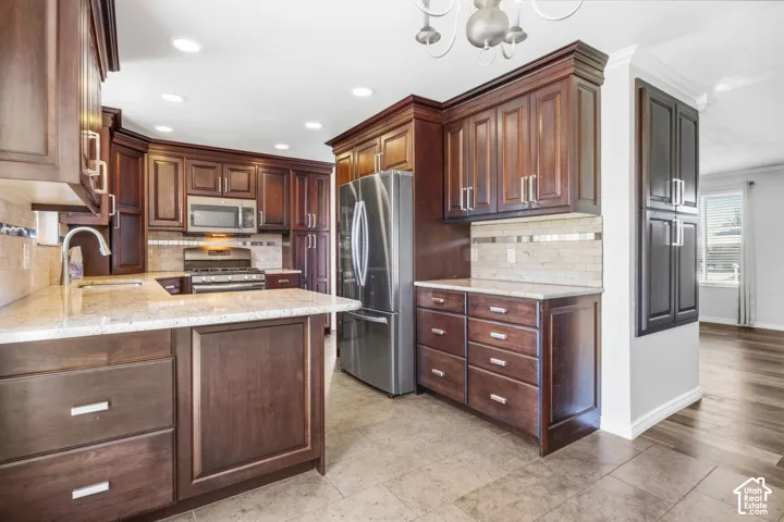 Full kitchen featuring wood cabinetry, stainless steel appliances, and light-toned countertops
