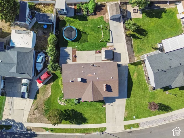 Expansive property featuring a brown shingle roof, concrete driveway, and a large manicured lawn