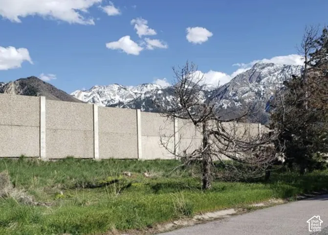Concrete sound barrier wall with a mountain backdrop