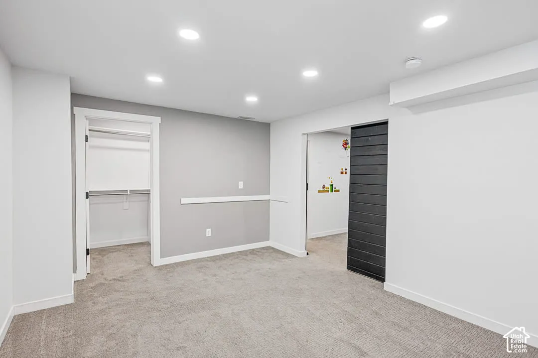 Bedroom with walk-in closet and farm-style door - Basement