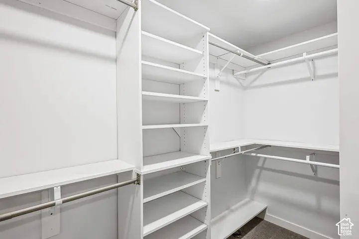 Walk-in closet with custom closet system - Basement
