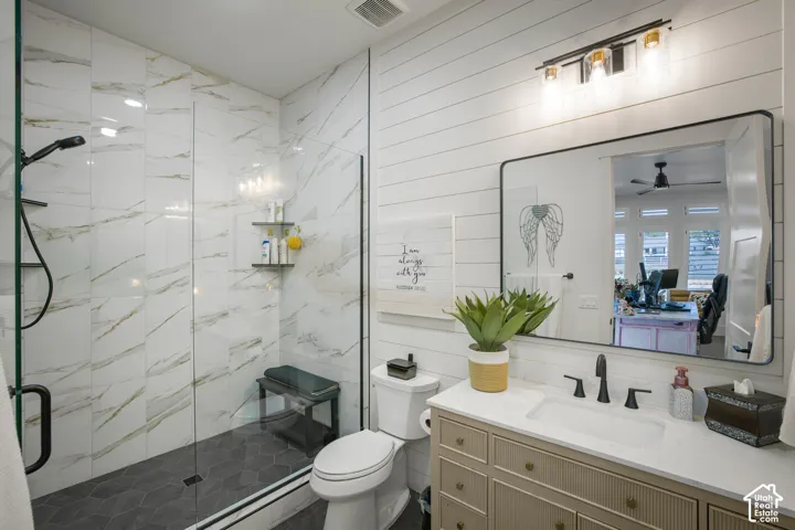 Walk-in shower with full-height tile surround and glass enclosure