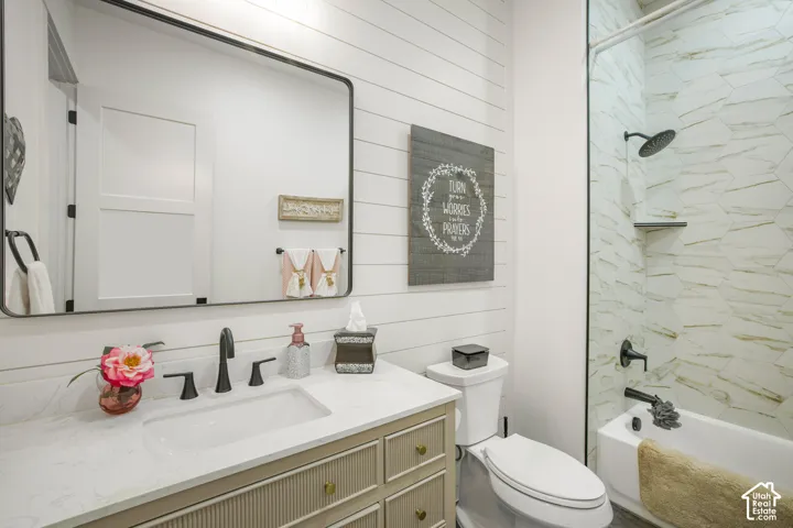 Vanity with a solid surface countertop, undermount sink, and matte black fixtures
