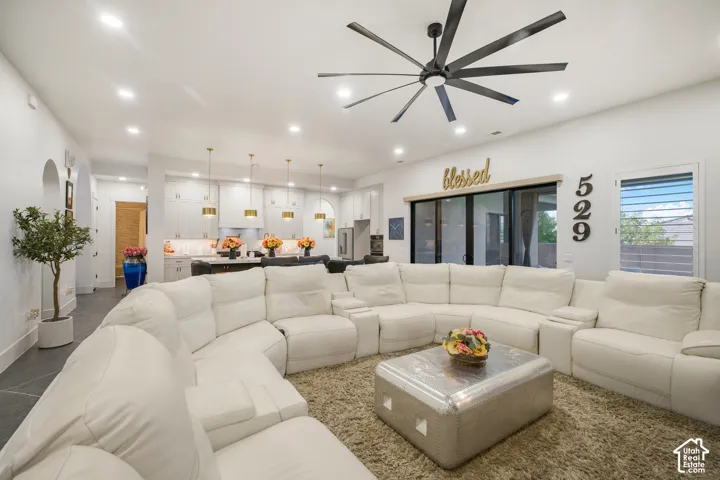 Open-concept living space featuring recessed lighting, a modern ceiling fan, and sliding glass doors